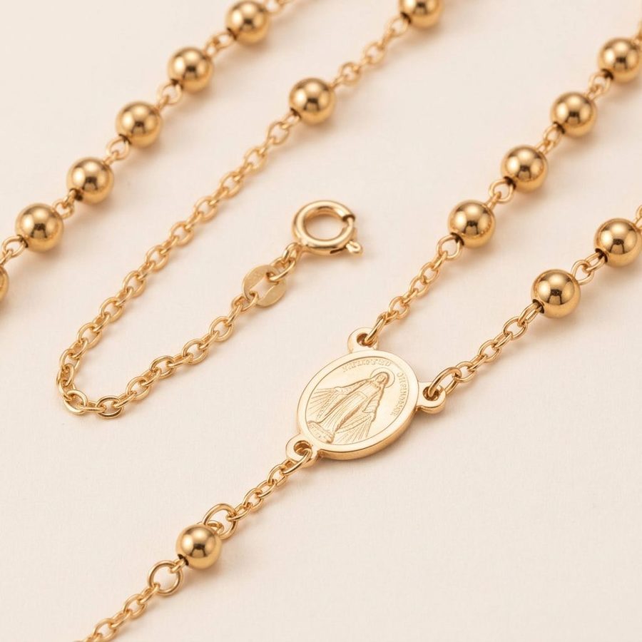 Gold rosary chain and medal detail
