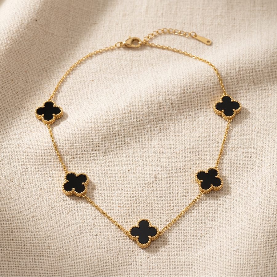 Black clover necklace on linen