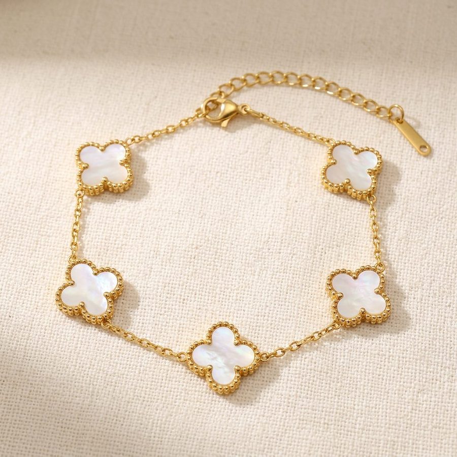 White mother of pearl clover bracelet on warm linen