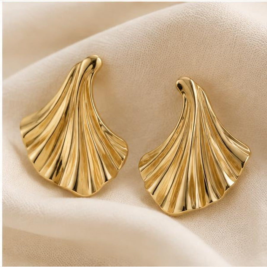 Golden Leaf Fan Earrings on soft fabric