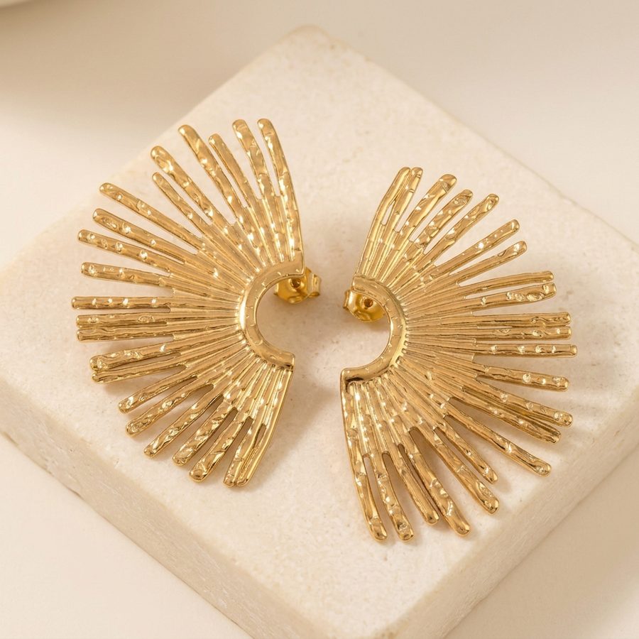 Gold sunburst fan earrings on a stone riser