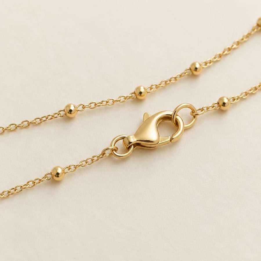 Gold clasp and beaded chain detail