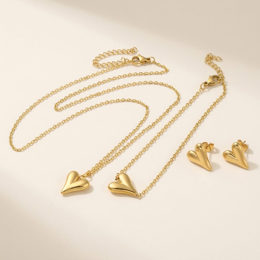 Gold heart stud earrings with matching necklace and bracelet