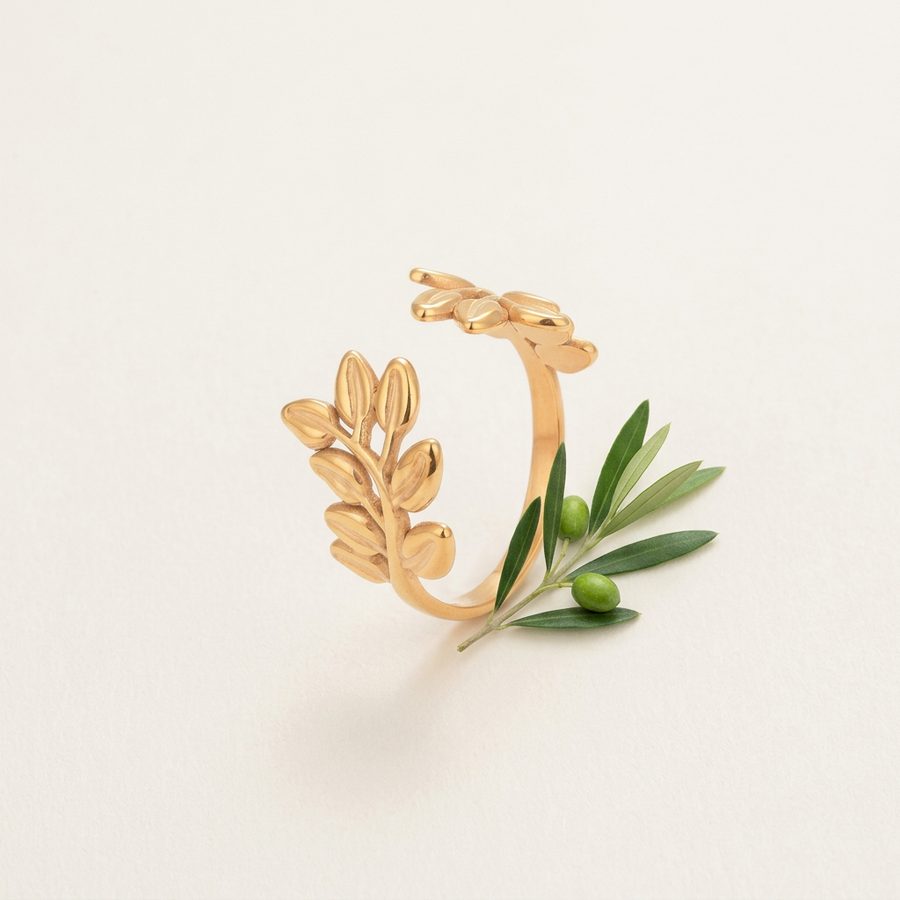 Olive branch ring flat lay with olive sprig